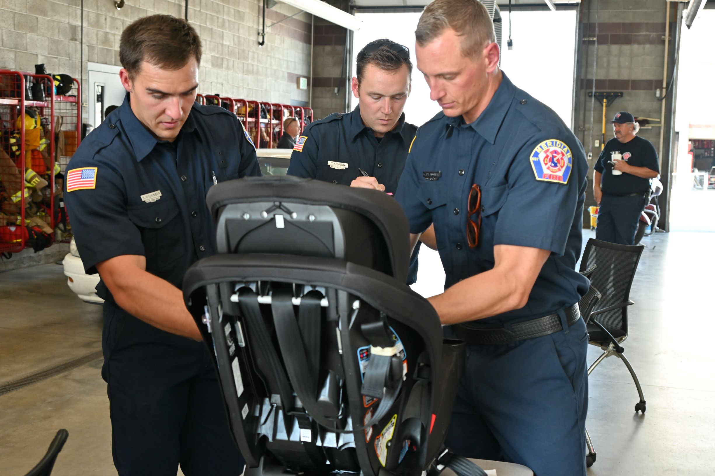 firefighters helping to install a car seat